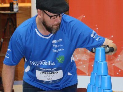 CYBATHLON pilot builds a tower with cups using his prosthetic arm